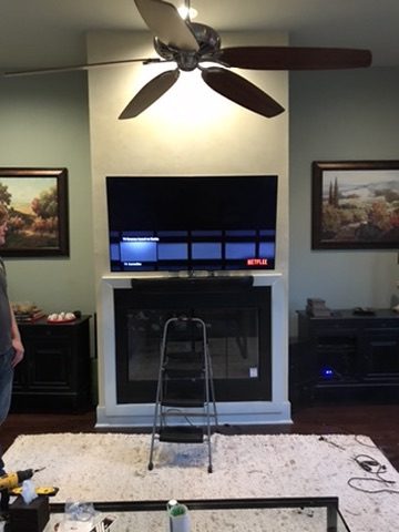 TV mounted above fireplace during installation