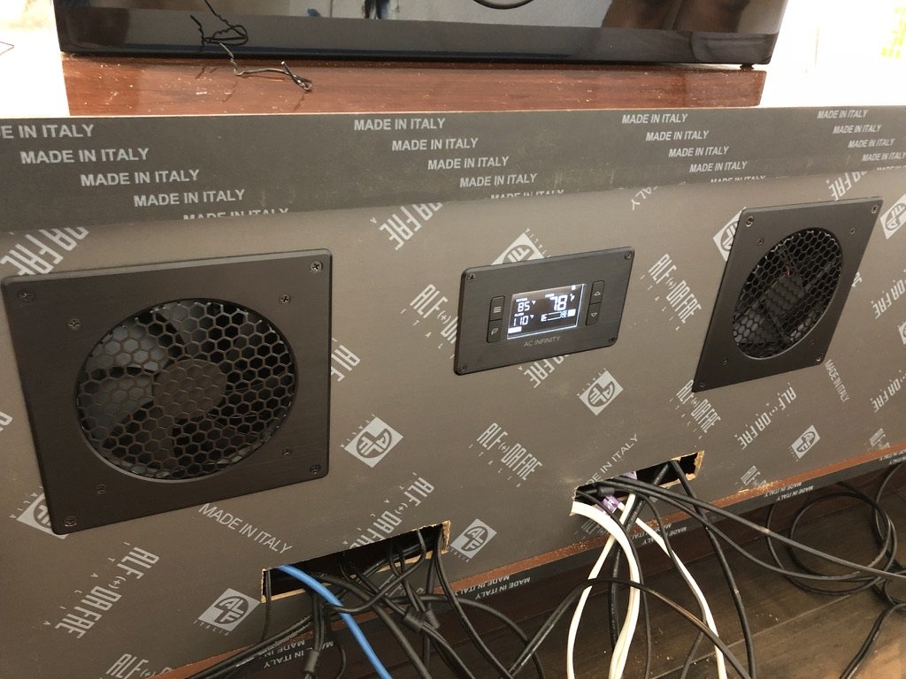 Custom ventilation panel built into a console housing hi-fi components